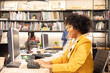 © anon - Young African American female architect working in an office.Portrait of a confident black businesswoman with all african american team in working room.