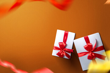 White gift box with red ribbon with a colored background