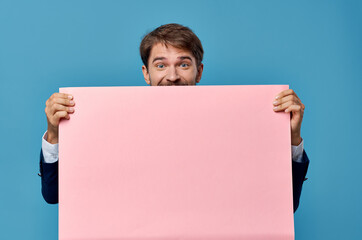 Wall Mural - emotional man pink paper in the hands of marketing fun Lifestyle isolated background