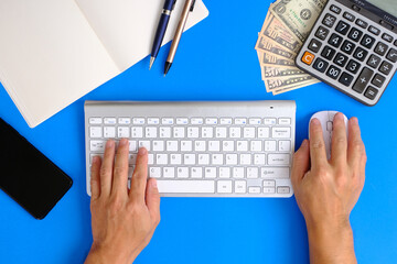 Poster - Hands of a man working on a modern laptop Banking and money themes on a background in an office.