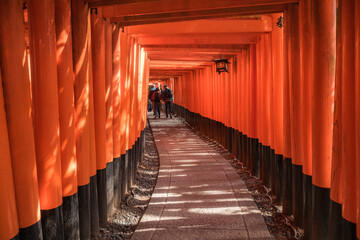 People visit Fushimi Inari Taisha, the Shinto shrine located in Fushimi-Ku Kyoto, Japan. Senbon Torii is an impressive corridor with about a thousand torii gates built on Mt Inari.