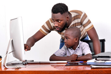 Wall Mural - young father teaches his little boy to use a laptop.