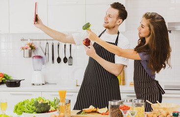 Positive couple with healthy food taking selfie