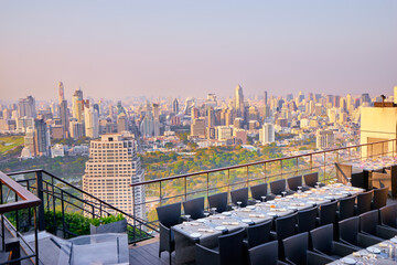 Sticker - Table setting on roof top restaurant with megapolis view, Bangkok Thailand.