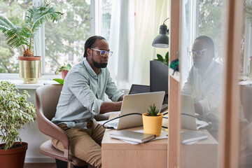 Concentrated man sitting at the computer while working from home