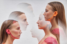 Multiple Exposure Of Young Twin Sisters Face To Face By White Background