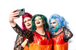 © VISTA by Westend61 - Men with multi colored dress and wig taking selfie through smart hone against white background
