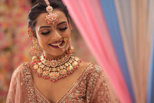 Portrait Of Beautiful Smiling Indian Bride In Traditional Wedding Clothing And Jewellery
