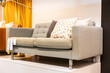 Stylish and inexpensive gray sofa in the showroom of a furniture store
