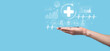 © Ivan - Businessman hold virtual plus medical network connection icons. Covid-19 pandemic develop people awareness and spread attention on their healthcare.Doctor,document,medicine,ambulance,patient icon.
