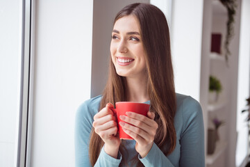 Poster - Profile side photo of young cheerful girl happy positive smile drink mug coffee tea morning look window dreamy indoors