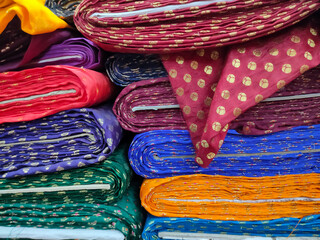 Rolls of fabric and textiles in shop. Multi colors indian patterns on the market Fabrics in rolls. Fabric store in Pune, Maharashtra, India.