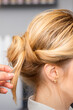 © okskukuruza - Close-up hairdresser styling blonde hair on the back of the head in a beauty salon