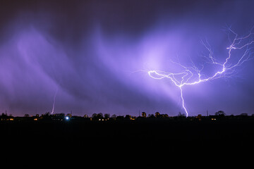 Wall Mural - bright branched bolt of lightning during an autumn thunderstorm