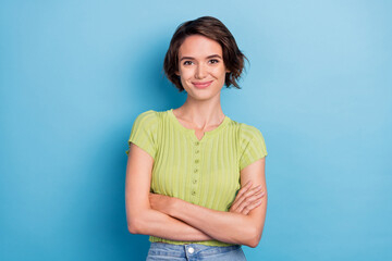 photo of attractive confident young lady wear green t-shirt smiling arms crossed isolated blue color