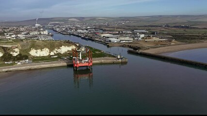 Wall Mural - Newhaven Port entrance with a jack up rig in the bay and Newhaven Fort in the background. Aerial Footage.