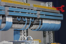 1-level And 3-level Electric Color Terminals With Connected White And Blue Mounting Wires Located On The Din Rail.