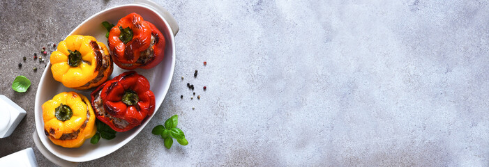 Wall Mural - Stuffed pepper. Paprika with rice and minced meat. Baked peppers on a concrete background..Top view.