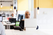© Nikola Spasenoski - African american muslim girl with hijab working on a laptop in an office..