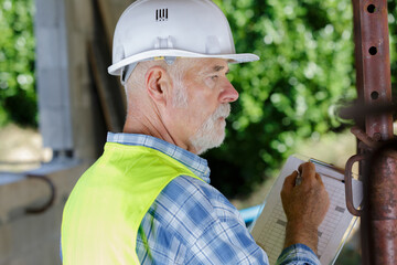 senior worker during pipes control