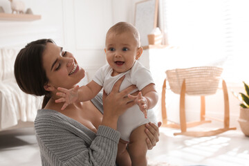 Poster - Happy young mother with her cute baby at home