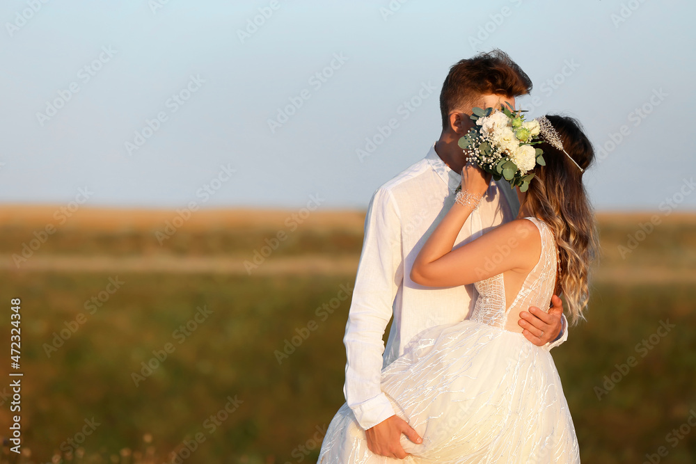 Happy wedding couple in countryside