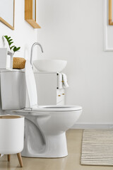 Poster - White toilet bowl and chest of drawers near light wall in restroom