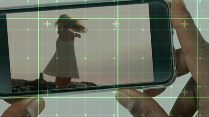 Poster - Animation of data processing over businessman holding smartphone with woman dancing