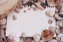 Sea Shells Frame, Notebook, Blank Sheet, Straw Hat  On Striped Background, Flat Lay, Mock Up, Copy Space. Sea Vacation, Travel Planning Concept