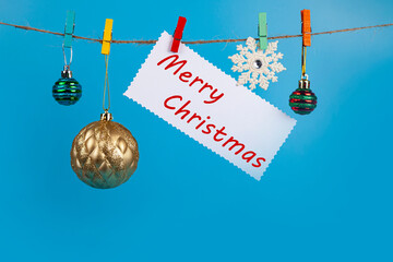 Wall Mural - Christmas decorations hang on a rope. Christmas card.