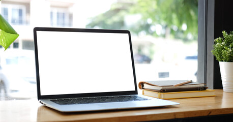 Fototapete - Close up computer laptop with white screen on wood table in modern office..