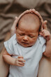 © Ananass - close up portrait of a beautiful sleeping baby in the arms of mom in the bedroom in daylight