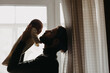 © Ananass - Silhouette of a stylish bearded father kisses a sleeping newborn girl. Parent holding rocking child daughter son in hands. Authentic lifestyle parenting fatherhood moment. Single dad family home life.
