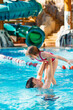 © andrey - dad and daughter have fun and play in the pool. swimming training.