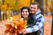 © soleg - Portrait of a couple in an autumn city park - happy people posing together, beautiful nature with yellow leaves as background.