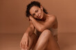 © Taras Grebinets - Beautiful middle aged woman with skin flaws and stretch marks after pregnancy and childbirth, looking confidently at camera. Self-acceptance and body love, body positive concept with copy ad space