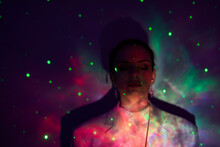 Portrait Of Young Woman Against Illuminated Colored Background