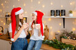 © Олеся Болтенкова - Good Christmas morning. Sisters drink tea at the kitchen table with cookies the kitchen. A time of miracles and fulfillment of desires. Merry Christmas.