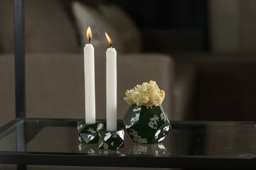 Two stone Candle Holder with abstract smudges, green concrete with silver flame. selective soft focus. White moss in a concrete pot