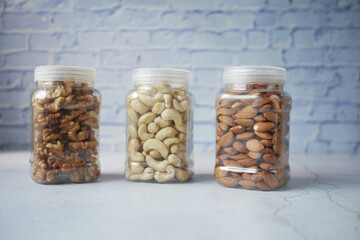 walnut , cashew nut and almond in a container on table 