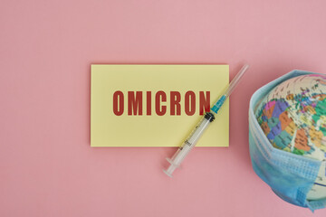 Globe in face mask and syringe. New vaccine against Covid-19 Omicron variant. Symbol of global roll-out new generation of vaccine against Omicron strain of coronavirus. Omicron variant vaccine