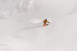 freeride skier rides on powder snow down the slope