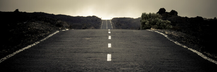 banner header with long straight asphalt road in country side with horizon in background. travel and