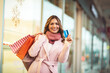 © Mediteraneo - Christmas Shopping. Beautiful happy woman with credit card and shopping bags