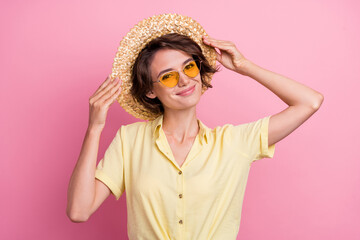 Poster - Photo of sweet millennial brunette lady wear yellow t-shirt cap eyewear isolated on pink color background