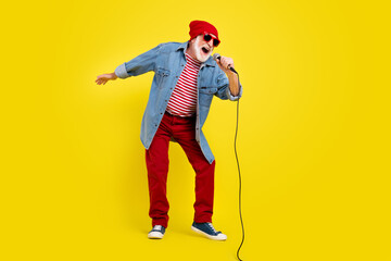 Poster - Full length body size view of attractive cheery grey-haired man singing hit having fun isolated over vivid yellow color background