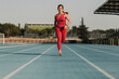 © Westend61 - Sportswoman running on sports track at stadium