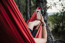 Woman Video Calling Female Friend Through Mobile Phone During Vacation