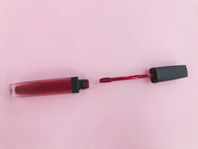 Lipstick On A Pink Bright Matte Background. Lipstick In A Trendy, Stylish Red Shade. Lipstick With A Soft Brush, Lip Makeup, Matte Gloss With Hydration