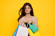© VICHIZH - cheerful woman multicolored packs emotions shopping fashion studio model